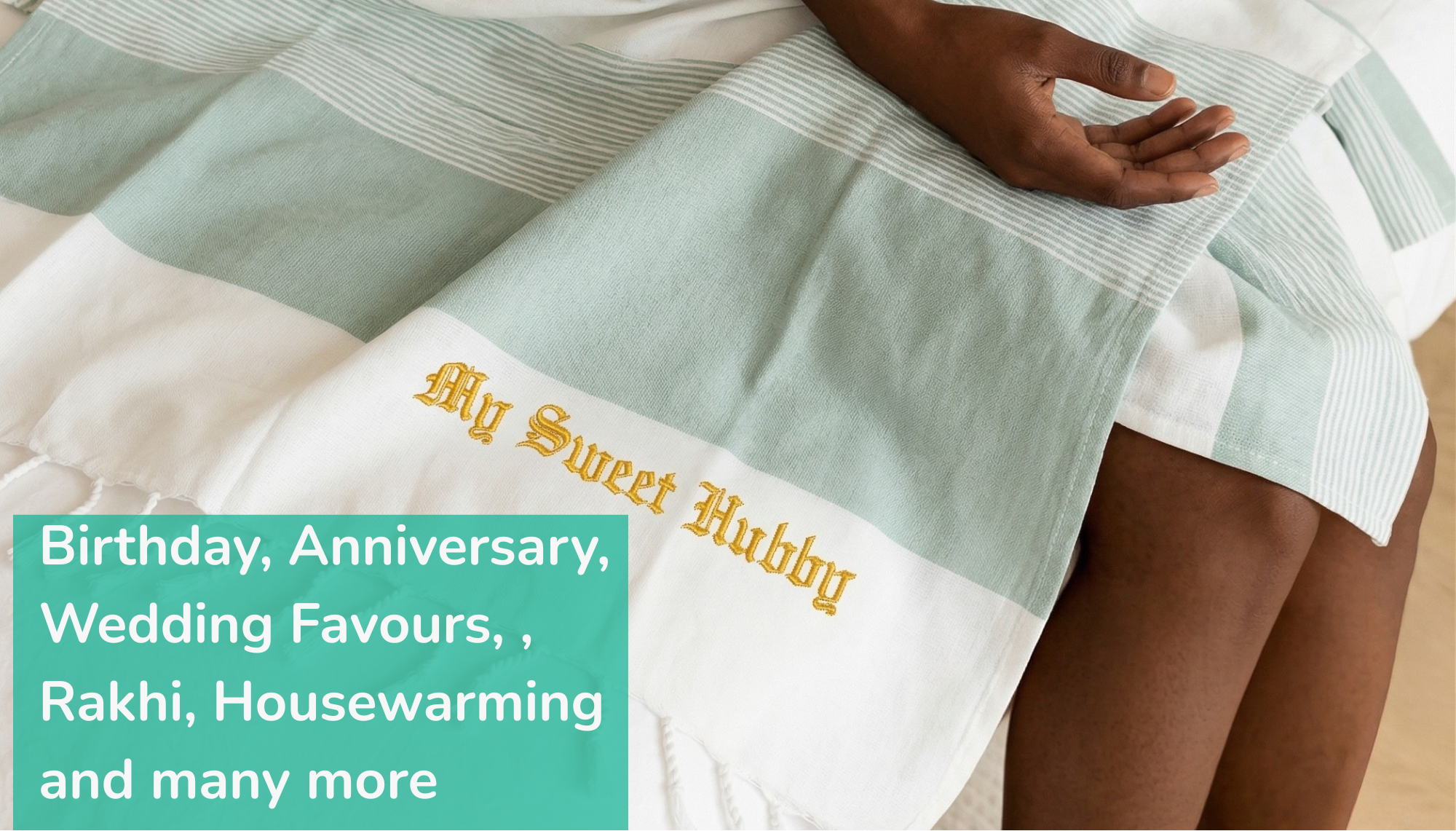 Person sitting on a bed with a personalized towel, surrounded by promotional text for gifts.